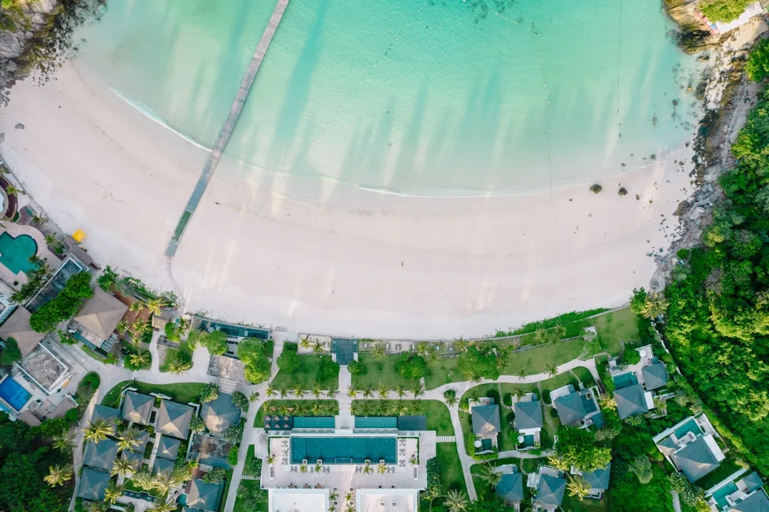 Panoramic view of top beach clubs in Phuket with infinity pools overlooking the Andaman Sea