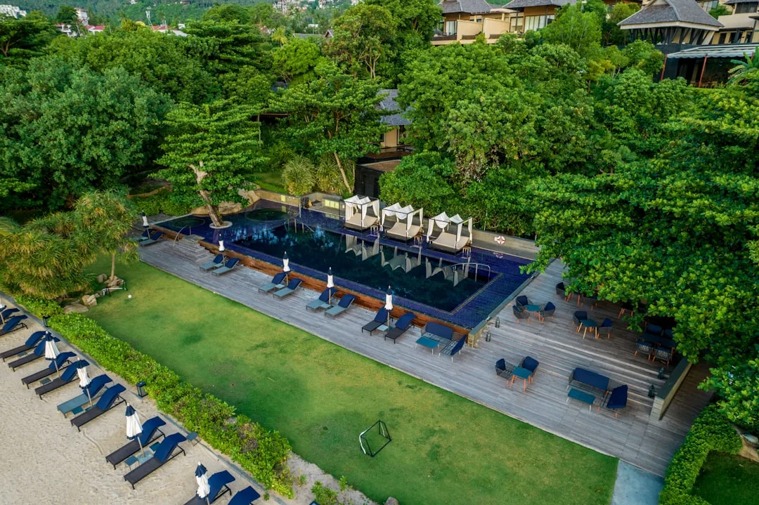 Rava Beach Club Phuket at Banyan Tree resort - luxury infinity pool and Andaman Sea sunset views on Bang Tao Bay