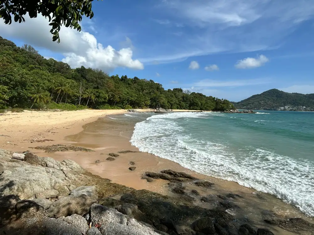 White sand and turquoise water at Freedom Beach Phuket, a secluded cove near Patong