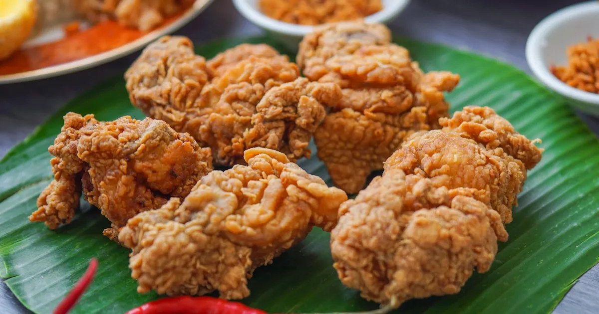 Selection of Thai street food dishes including moo ping, pad Thai, and mango sticky rice at a Phuket night market