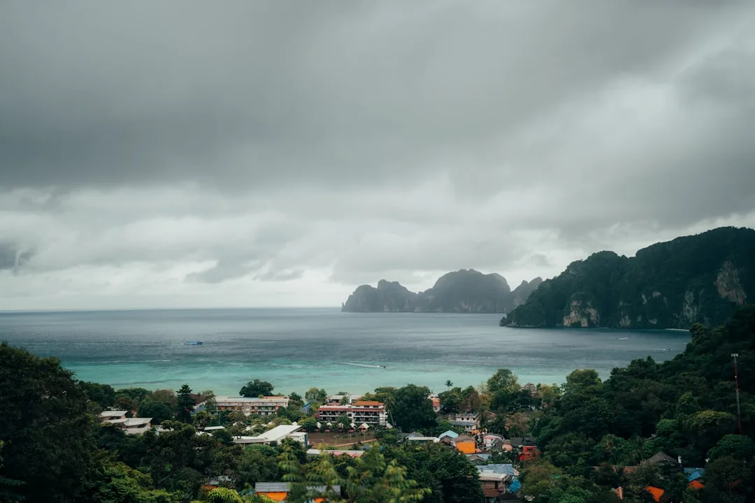 Phuket low season nightlife – rainy evening with lit-up bar fronts and locals out on a quiet street