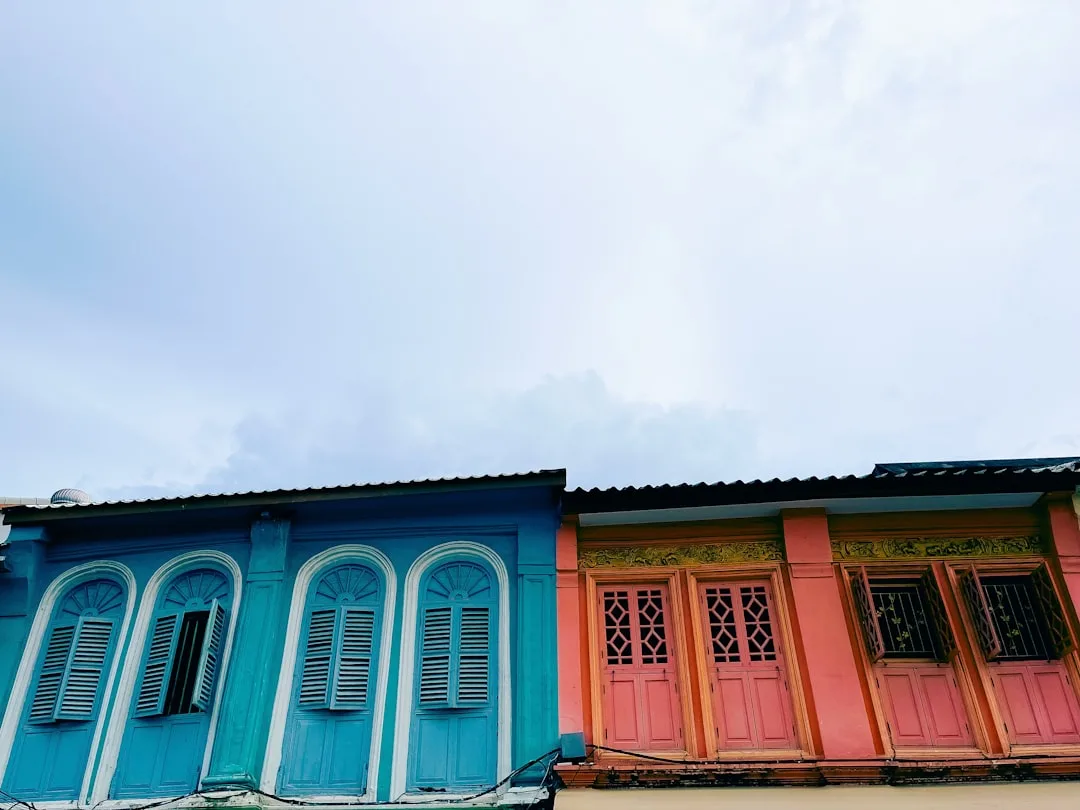 Restored Sino-Portuguese shophouse facades in Phuket Old Town with pastel colours and five-foot arcades