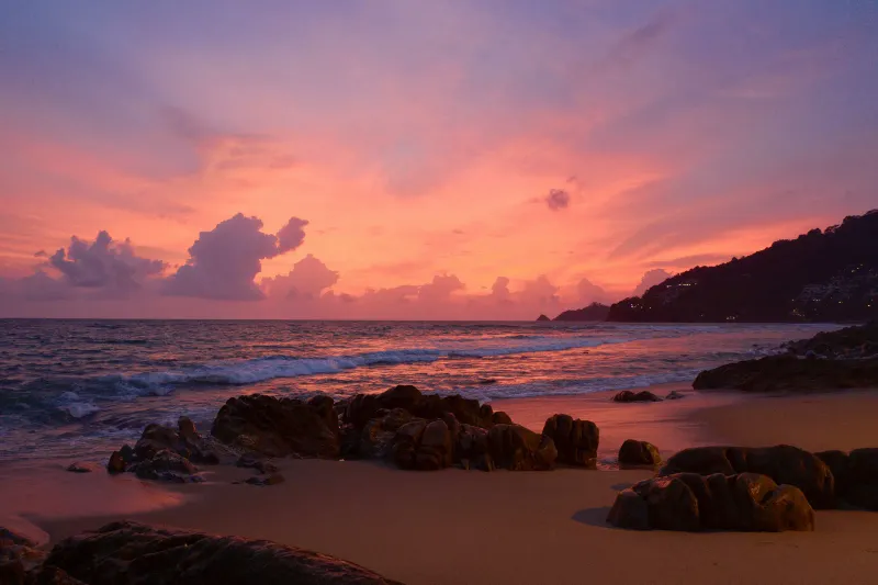 Sunset over a quiet Phuket beach, a calm contrast to the daytime Songkran water fights